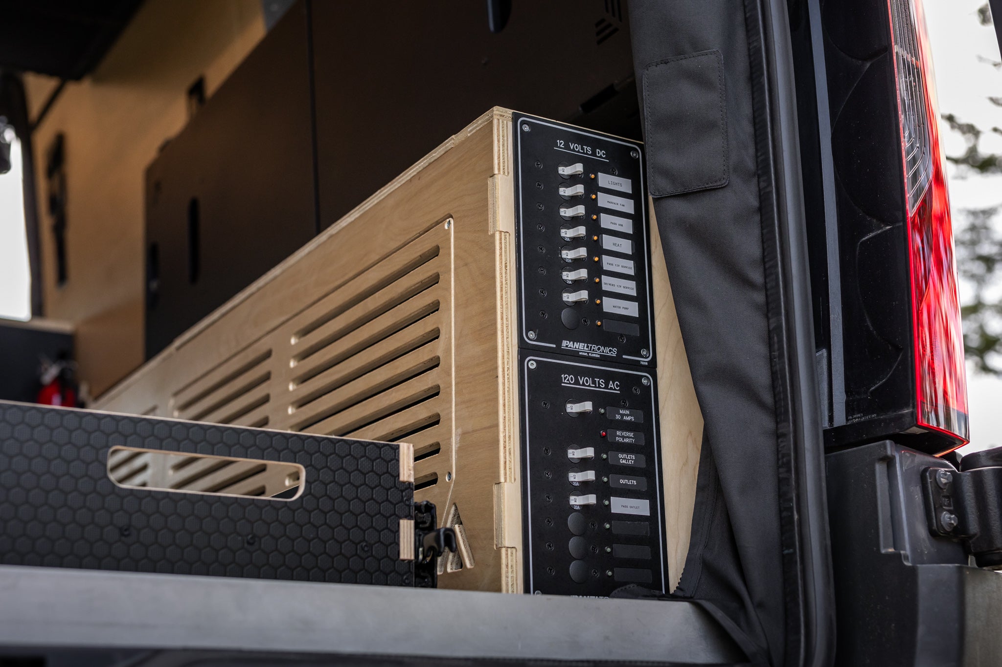 Electronic equipment in a vehicle's open door with visible branding.